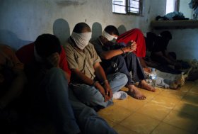 A group of people kidnapped by alleged drug-traffickers, sit on the floor after being rescued by members of the Mexican Army in Sabinas Hidalgo, 99 km north of Monterrey, Nuevo Leon State, Mexico, on April 27, 2010. Sixteen people, including a woman and a two-year girl, were rescued during the operation. AFP PHOTO/Dario Leon (Photo credit should read Dario Leon/AFP/Getty Images)